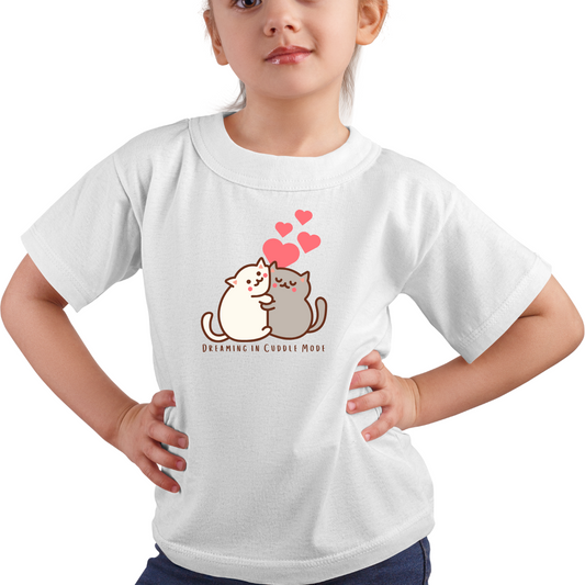 Child wearing a white t-shirt with cartoon cats and text on a white background